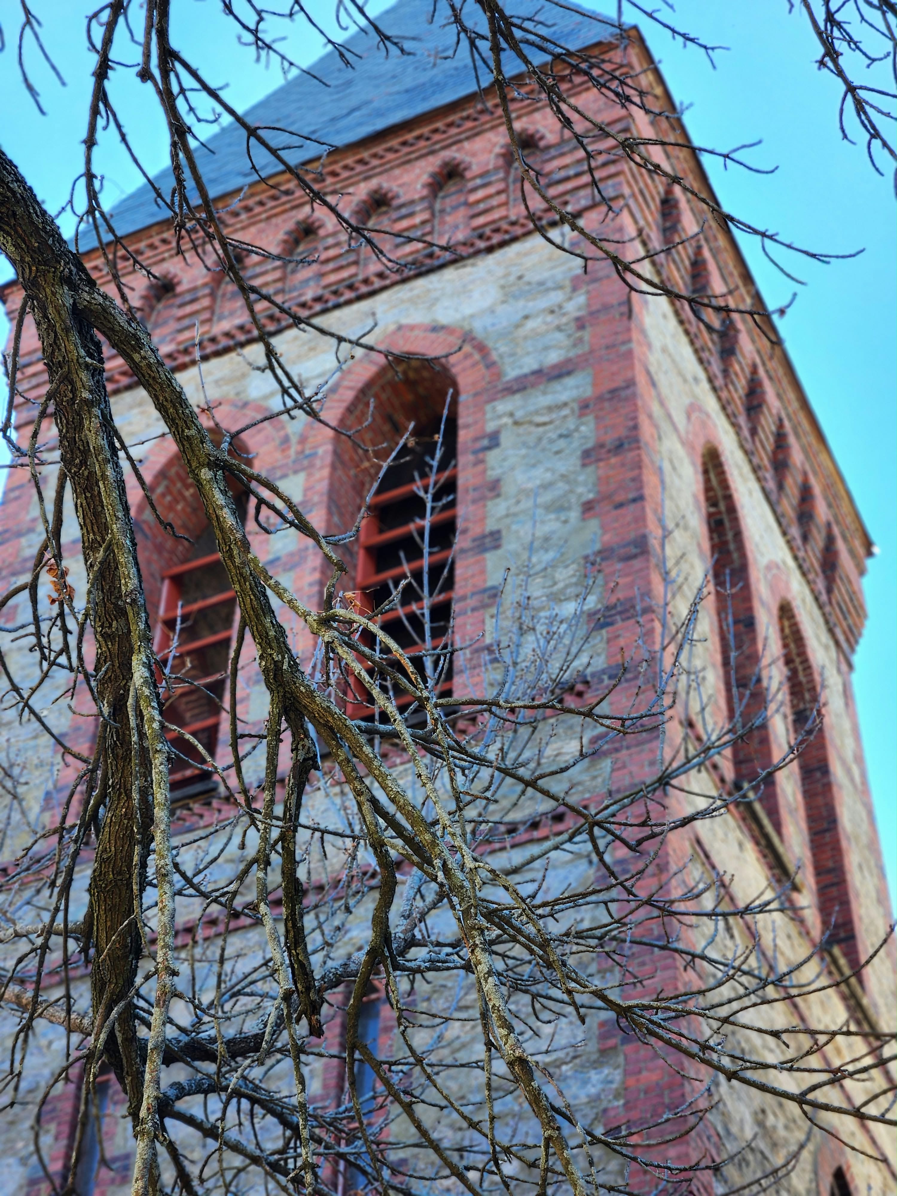 Brick tower framed by tree branches